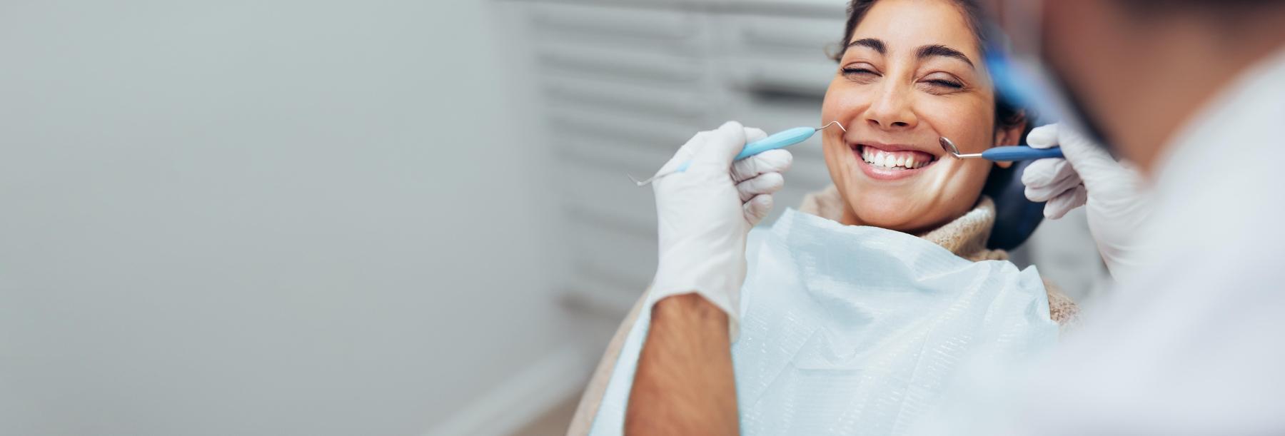Patient smiling after dental implant placement in Norfolk MA