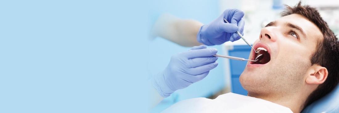 Man receiving dental exam from dentist in Norfolk MA