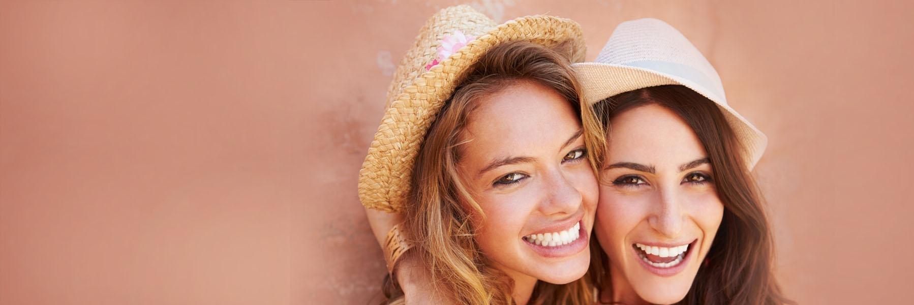 Two girls smiling | Dental Emergencies Norfolk MA