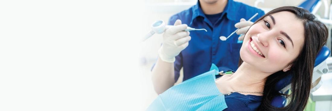 Patient smiling in chair at dentist in Norfolk MA