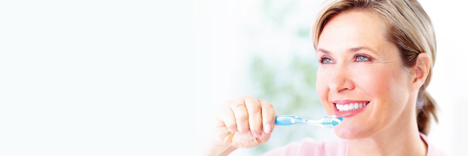 Woman brushing her teeth | Family Dentist Norfolk MA