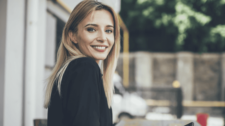 A smiling woman looking back at the camera
