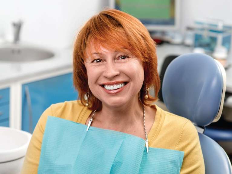 A smiling woman at the dentist