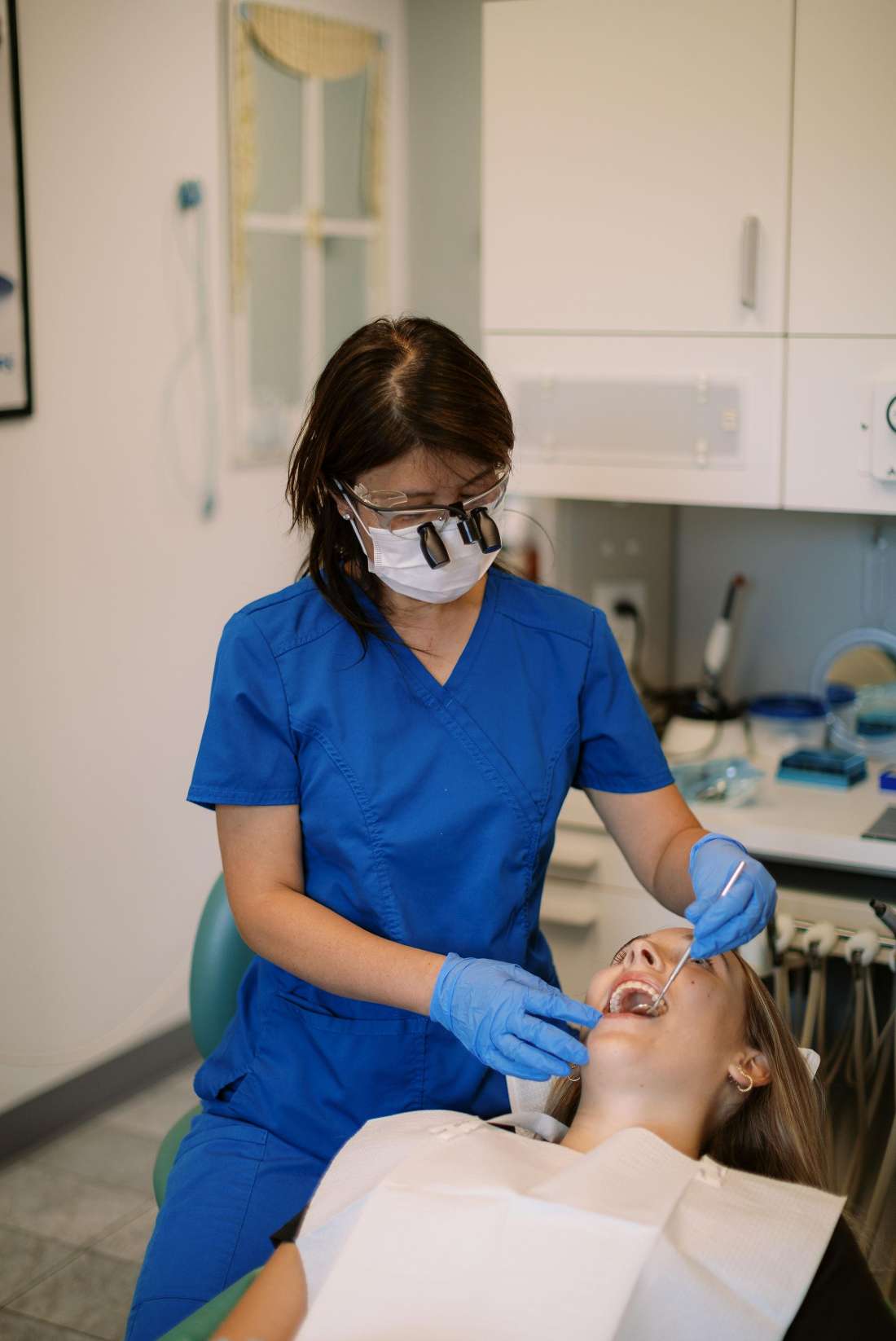 A dentist giving a patient a dental cleaning in Norfolk, MA