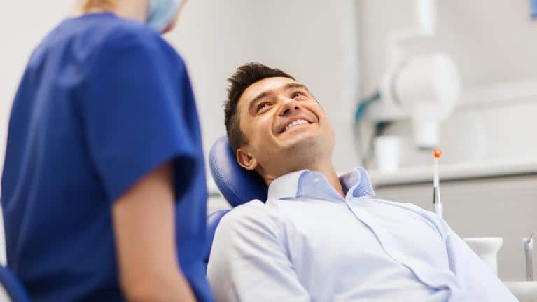 Man smiling at the dentist office in Norfolk, MA