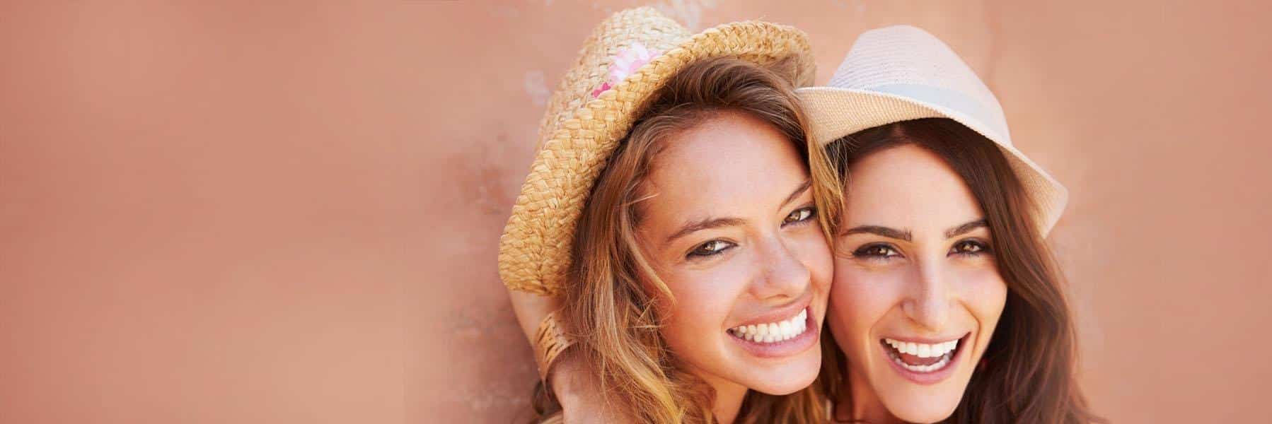 Two girls smiling | Dental Emergencies Norfolk MA