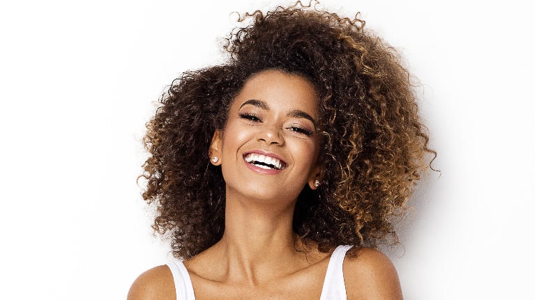 Patient smiling at cosmetic dentist office in Norfolk
