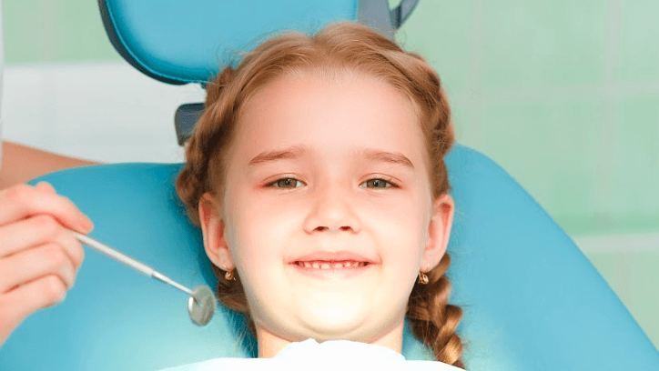 A smiling child getting a dental exam