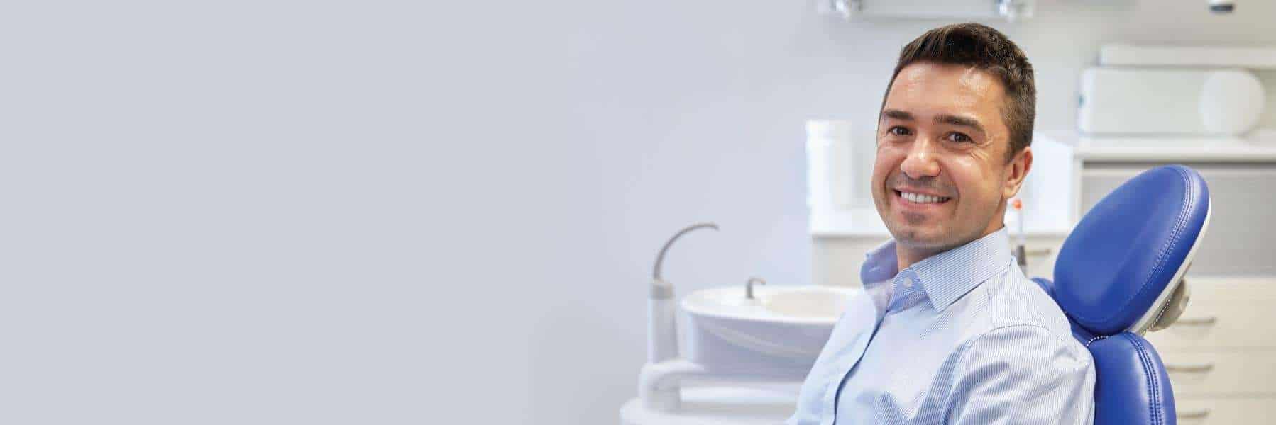 A smiling man in the dentist's chair