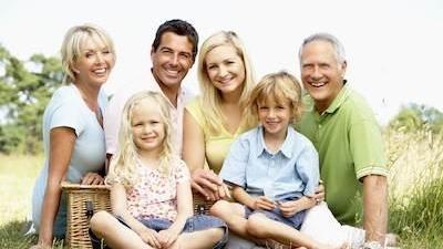 Large family sitting in a park near Norfolk MA