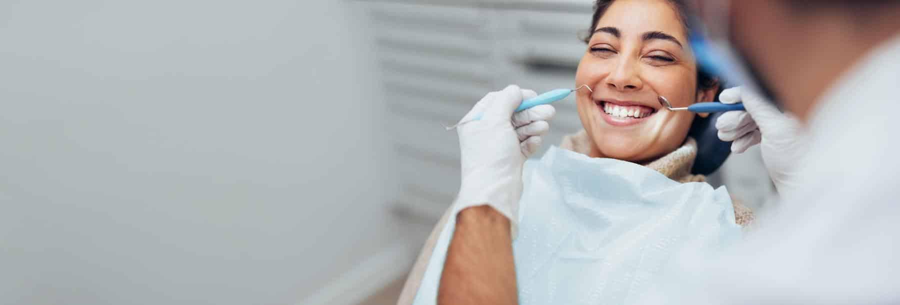 Patient smiling after dental implant placement in Norfolk MA