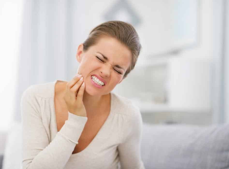 Woman in pain from dental emergency near 02056
