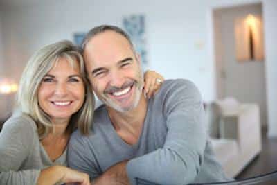 Happy married couple wearing porcelain veneers in Norfolk MA