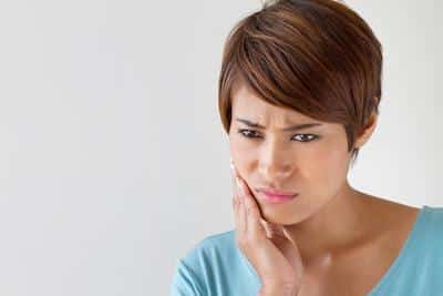 Woman with bad tooth pain from dental emergency near Norfolk MA